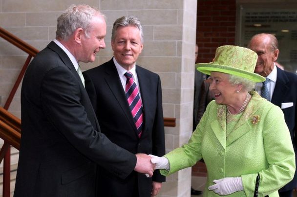 June 27, 2012: Queen Elizabeth II shakes hands with Northern Ireland Deputy First Minister Martin McGuinness, watched by First minister Peter Robinson (centre) at the Lyric Theatre in Belfast.
