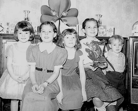 Kate (second from left) and her four siblings celebrating their Irish Ancestry on a St. Patrick’s Day long ago.