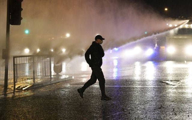 PSNI deploy a water cannon against nationalist rioters.