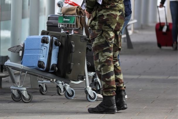 March 26, 2021: Members of the Irish Defence Forces escort passengers with their luggage from high-risk countries to their bus outside Terminal 2 in Dublin Airport.