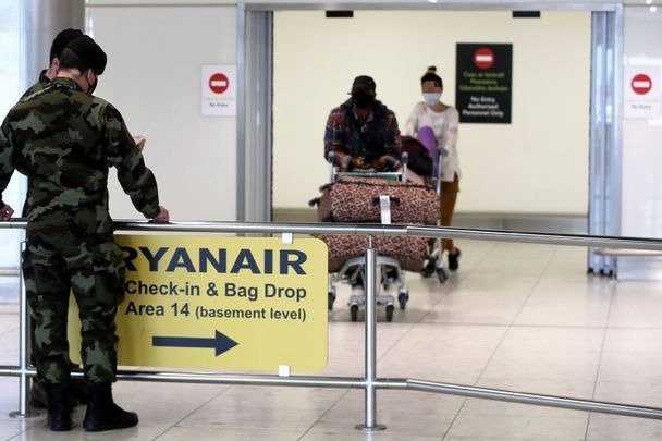 April 15, 2021: Members of the Irish Defence Forces escort passengers at Dublin Airport to awaiting coaches to be transferred to Hotels for Mandatory quarantine. 