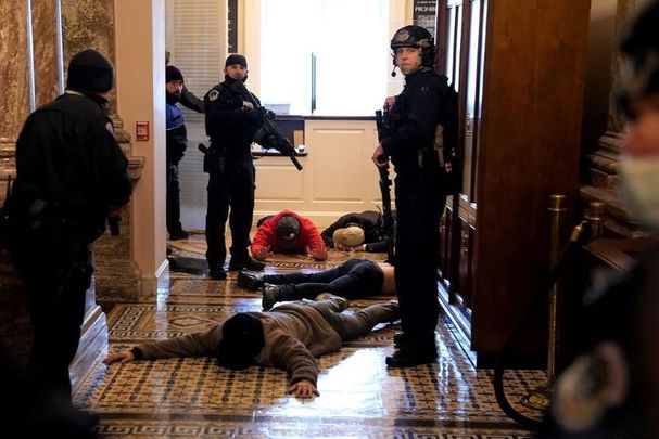 January 6, 2021: U.S. Capitol Police detain protesters outside of the House Chamber.
