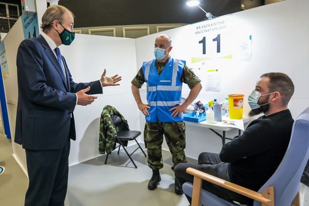April 7, 2021: Taoiseach Micheal Martin speaking to vaccinator Tony O\'Sullivan from the Defence Forces and Jason Gleeson from Kilcock, as he visited the HSE Covid-19 Vaccination Centre in the Citywest Conference Centre in Dublin. 