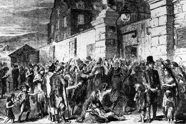 1846: Starving peasants clamor at the gates of a workhouse during the Irish potato famine.