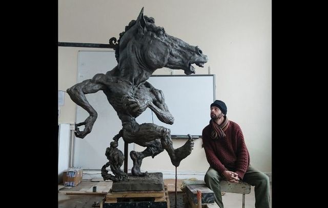 Aidan Harte with his Púca of Ennistymon sculpture. (Courtesy @aidanhartesculptor, Instagram)