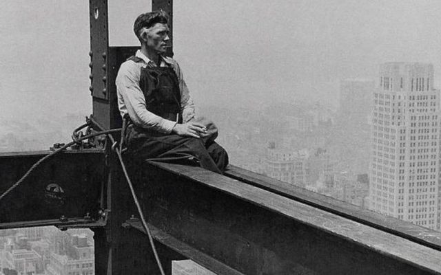 An immigrant worker takes a break while building the Empire State Building. 