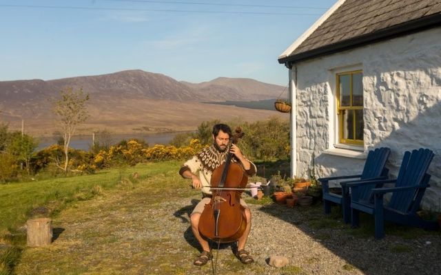 Patrick Dexter playing the cello outside his home in County Mayo