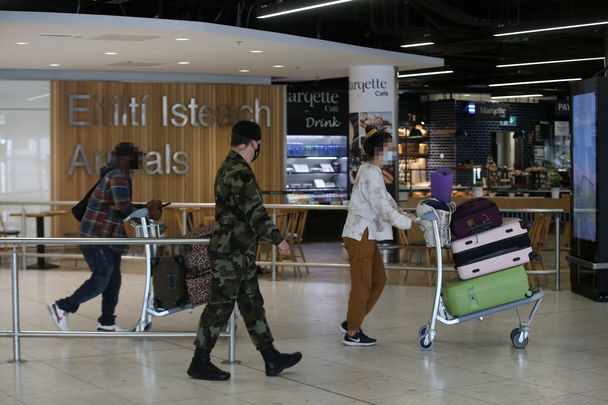 Military oversee arrivals at a quiet Dublin Airport.