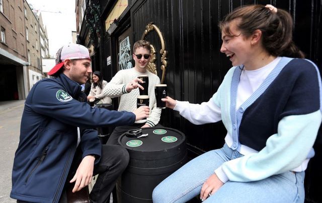 June 7, 2021: Karl Devereux (Cap) with Ronan Bennett and Daisy O Sullivan having a pint of Guinness as outdoor dining begins in Dublin City centre on the day outdoor dining reopened. 