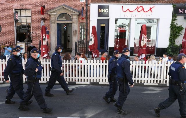 Police patrol South William Street, in Dublin City Center, as people enjoy outdoor dining during the fine weather.