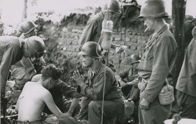 US soldiers receiving medical care during the Korean War.