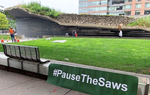 July 8, 2021: A \"Pause the Saws\" sign outside of the Irish Hunger Memorial in Battery Park, downtown Manhattan NYC.