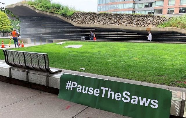A \'Pause the Saws\' sign outside of the Irish Hunger Memorial in NYC on July 8, 2021.