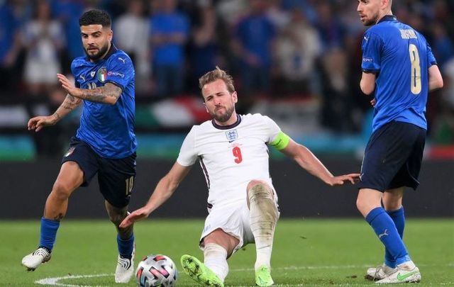 July 11, 2021: Harry Kane of England is challenged by Lorenzo Insigne and Jorginho of Italy during the UEFA Euro 2020 Championship Final between Italy and England at Wembley Stadium in London, England. 