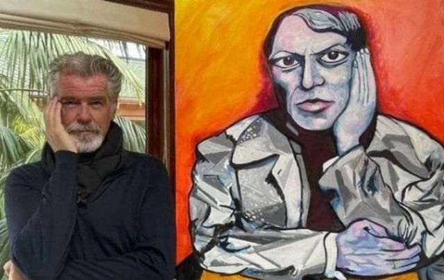 Pierce Brosnan alongside one of his paintings. 