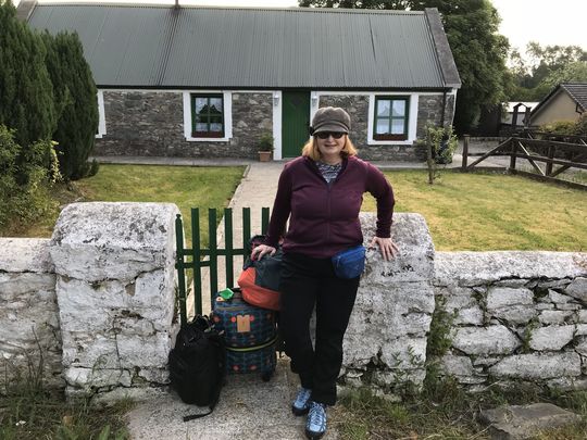 Jannet L. Walsh, of Murdock, Minnesota, poses in front of Crosstown Cottage, near Killarney, County Kerry, Ireland, June 1, 2018, before heading to the railway station in Killarney.  Walsh spent most of May living in the historic cottage researching and writing about her family’s Irish roots, and connecting with local Irish culture and people.