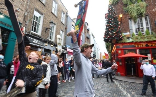 Protestors raise their skateboards outside the Temple Bar pub in Dublin. 