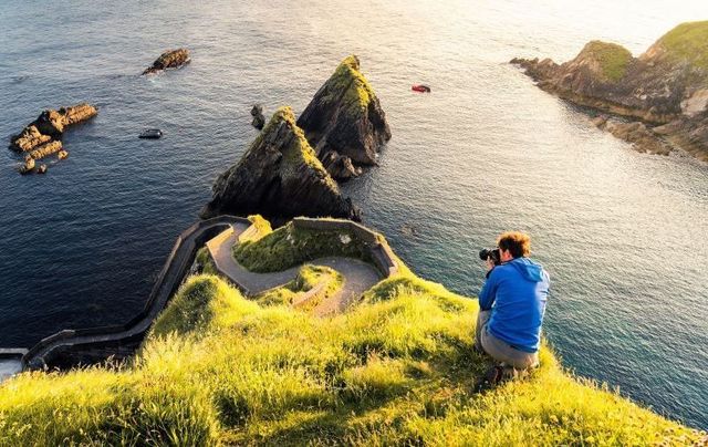 A photographer at Dunquin on the Dingle Way in Co Kerry.