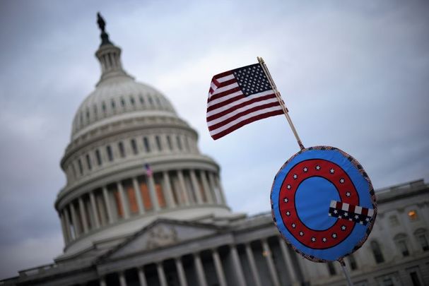 January 6, 2021:A U.S. flag with a symbol from the group QAnon as they gather outside the U.S. Capitol in Washington, DC.