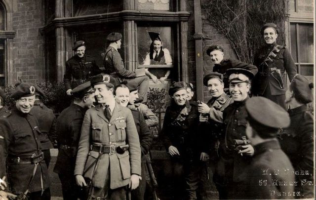 April 11, 1921: This shot of joking Black and Tans and Auxiliaries was taken outside the London and North Western Hotel, North Wall, Dublin as they surveyed the damage after an IRA attack on their quarters. Written on the mount of this photo was \"Tans glad to have escaped the bombs thrown at their headquarters in Dublin\".