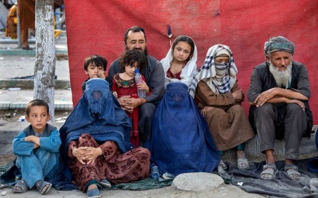 August 12, 2021: Charyar,70, from the Balkh province, sits alongside his family at a makeshift IDP camp in Share-e-Naw park to various mosques and schools in Kabul, Afghanistan. People displaced by the Taliban advancing are flooding into the Kabul capital to escape the Taliban takeover of their provinces.