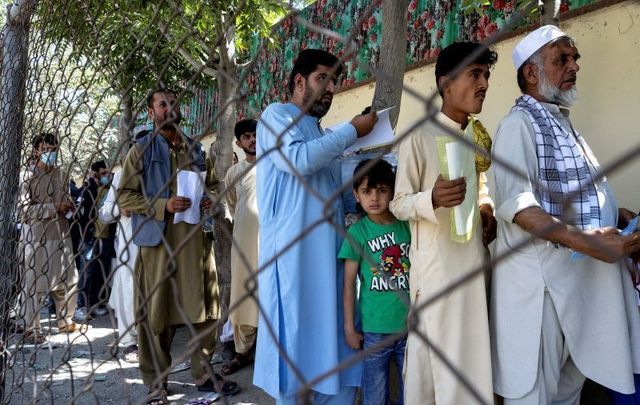 August 14, 2021: Afghans wait in long lines for hours at the passport office as many are desperate to have their travel documents ready to go in Kabul, Afghanistan.