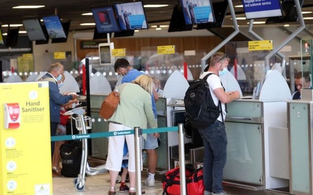 Travelers check in for flights at Dublin Airport. 