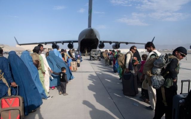 Afghan residents evacuate Afghanistan at Kabul International Airport on August 24. 