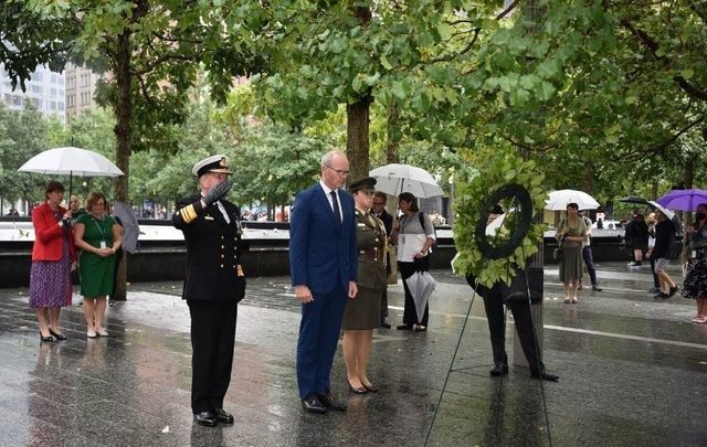 Simon Coveney (center) lays a wreath at the 9/11 Memorial. 