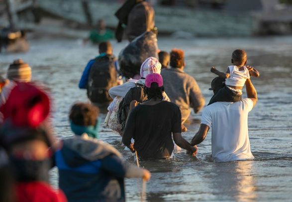 Haitian immigrant families cross the Rio Grande into Del Rio, Texas on September 23, 2021, from Ciudad Acuna, Mexico