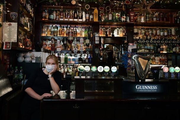 December 20, 2021: Ireland Begins Nightly Curfew For Pubs And Restaurants - Temple Bar staff member Caoimhe Everard looks out the window after closing early in Dublin, Ireland. The new rules, which last until January 30, require hospitality venues to shut nightly at 8 pm, in an effort to curb the spread of Covid-19 and its highly contagious Omicron variant. 