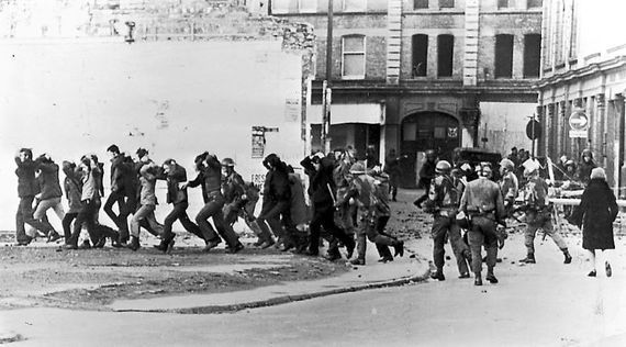 Members of the British Army\'s Parachute Regiment advance on marchers on Bloody Sunday. 