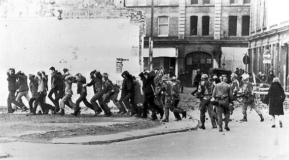 Members of the British Army\'s Parachute Regiment advance on marchers on Bloody Sunday.