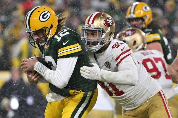 January 22, 2022: Aaron Rodgers #12 of the Green Bay Packers protects the ball as Arik Armstead #91 of the San Francisco 49ers defends in the NFC Divisional Playoff game at Lambeau Field in Green Bay, Wisconsin. 