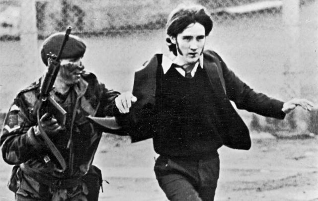 January 30, 1972: A British paratrooper takes a captured youth from the crowd on \"Bloody Sunday,\" when British paratroopers opened fire on a civil rights march, killing 14 civilians, in Derry, Northern Ireland. 