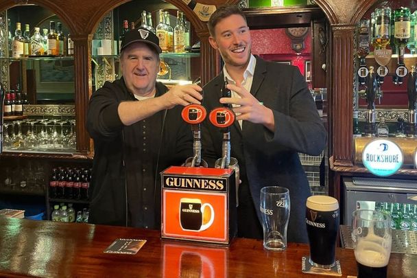 John McDonagh, left, finally gets his two pints of Guinness promised to him by Shane Gaffney nine years ago.