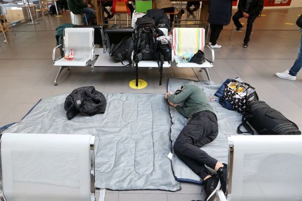 October 24, 2022: Ukrainian refugees sleeping on the floor at Dublin Airport as they are looking for accommodation. 