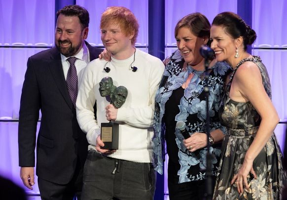 Ed Sheeran receives his award from Irish Arts Center Executive Director Aidan Connolly, musician Joanie Madden and the center’s vice chair Pauline Turley.