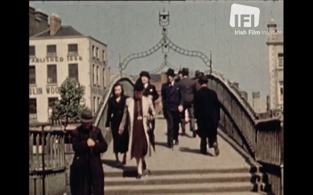 Pedestrians on Dublin\'s Ha\'penny Bridge as seen in the 1940 travelogue \"Dublin, Capital City of Ireland.\"