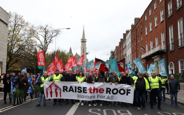 Protesters march during Saturday\'s Raise the Roof rally. 