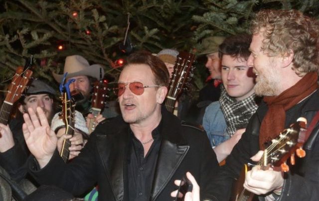 Bono and Glen Hansard busk on Grafton Street on Christmas Eve in 2013. 