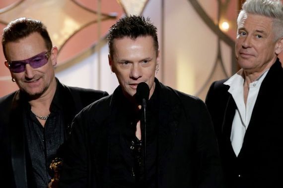 U2\'s Larry Mullen Jr. (center) flanked by Bono and Adam Clayton. 
