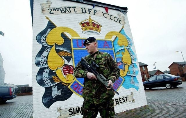 February 6, 2003: British army soldiers patrol the Lower Shankill area in front of a mural by the Ulster Defense Association (UDA), the largest Protestant paramilitary group in the district, in Belfast, Northern Ireland.