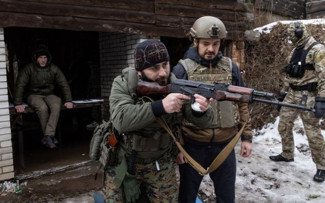 FEBRUARY 10: A member of the Georgian National Legion paramilitary volunteer unit (L) instructs a civilian on shooting techniques during a training course at a shooting range on February 10, 2022, in Kyiv, Ukraine. 