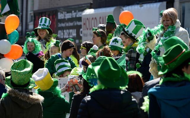 Revelers cheer on the marchers during a St. Patrick\'s Day Parade.