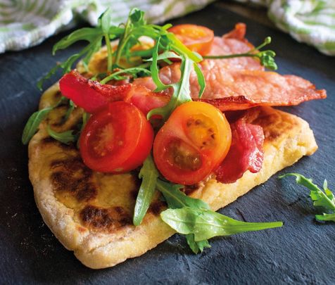 Irish potato bread topped with tomato and bacon.
