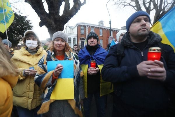 Ukraine supporters hold a candlelight vigil at the Ukrainian Embassy in Dublin on Saturday. 