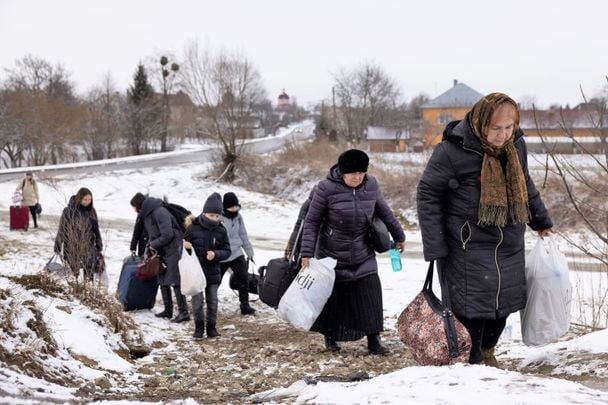 March 9, 2022: Refugees fleeing conflict make their way to the Krakovets border crossing with Poland in Krakovets, Ukraine. More than a million people have fled Ukraine following Russia\'s large-scale assault on the country, with hundreds of thousands of Ukrainians passing through Lviv on their way to Poland.