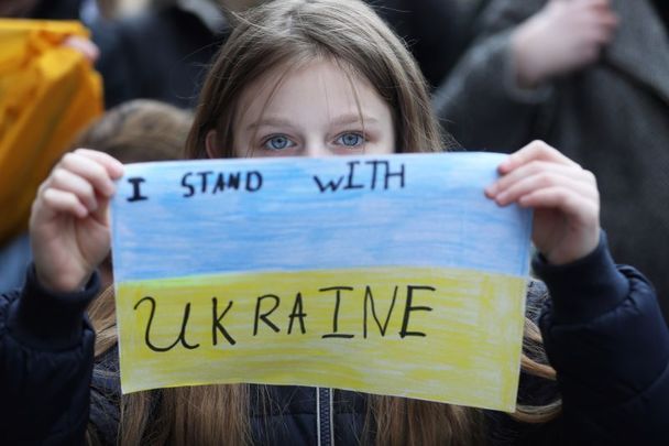 February 26, 2022: People at the GPO in Dublin protesting the Russian invasion of Ukraine. A 9-year-old Ukrainian girl holds a sign saying \"I Stand with Ukraine.\"