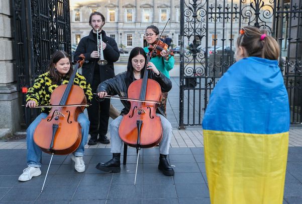 March 01, 2022: Ukrainian Caterina Reviakina (8) watches students from the Royal Irish Academy of Music play music in solidarity with Ukraine outside Leinster House, in Dublin. 